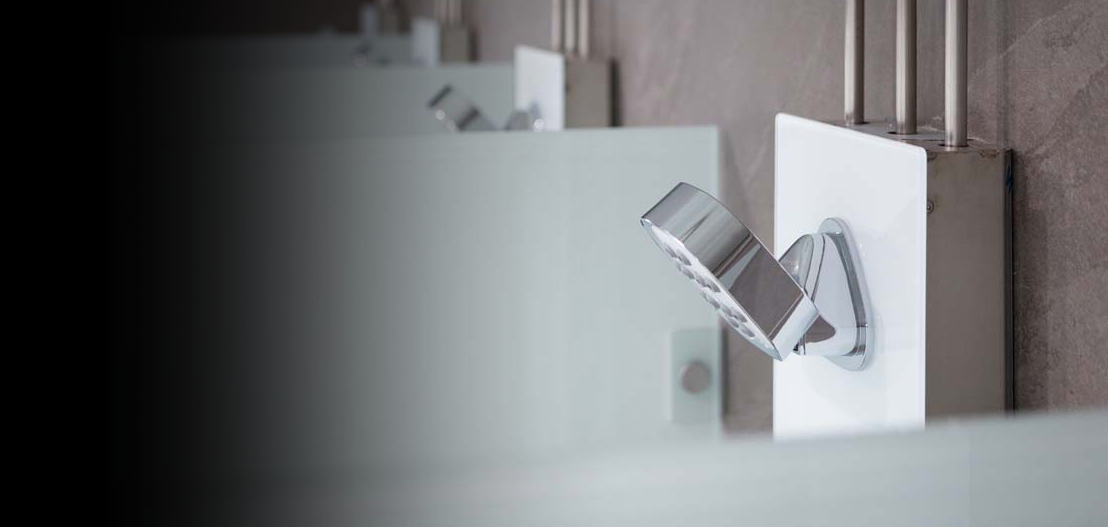 A row of Kelda showers within a washroom.